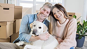 Husband and wife and their dog moving in new home - Young couple just moved into new apartment