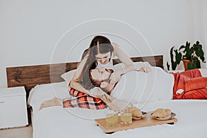 Husband and wife wake up in the morning in the bedroom weekend breakfast in bed