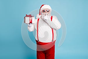 Hush its secret. Portrait of focused funny funky fat santa claus with big abdomen belly prepare gift for eve noel hold