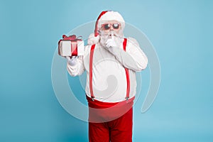 Hush its secret. Portrait of focused funny funky fat santa claus with big abdomen belly prepare gift for eve noel hold photo