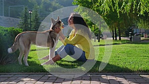 Husky dog with happy girl owner in green park