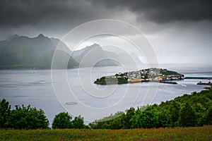 Husoy fishing village on the Senja Island in Norway with in heavy clouds