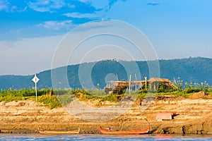 Hut on the banks of the Irrawaddy river, Mandalay, Myanmar, Burma. Copy space for text.