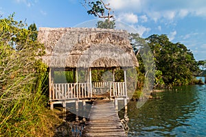 Hut built on Laguna Lachua lake, Guatema photo
