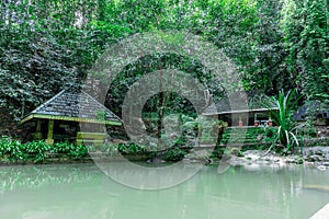 Hut at Kathu waterfall water gently flowing down the rocks Patong Phuket Thailand Asia