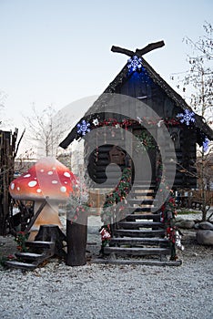 A hut made of dark wood. The hut of a character in Russian fairy tales. Baba Yaga`s House. The hut stands on chicken legs