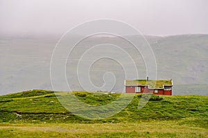 Hut wooden mountain huts in mountain pass Norway. Norwegian landscape with typical scandinavian grass roof houses. Mountain