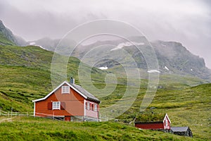 Hut wooden mountain huts in mountain pass Norway. Norwegian landscape with typical scandinavian grass roof houses. Mountain