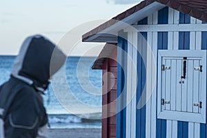 Huts with white and blue strips on the beach