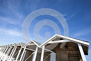 Huts wooden roofs. Blue sky with few clouds. HDR