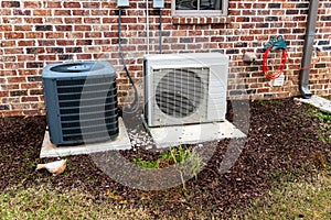 HVAC Air Conditioner Compressor and a Mini-split system together next to each other photo