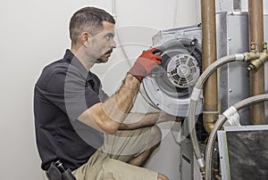 HVAC repair man working on a heat pump