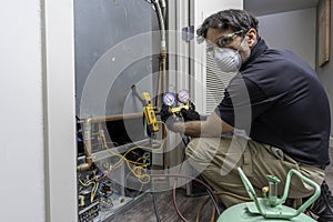 HVAC repairman charging ac unit