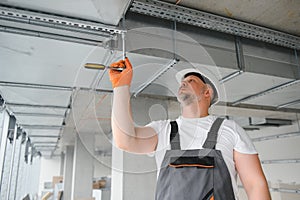hvac services - worker install ducted pipe system for ventilation and air conditioning in office.