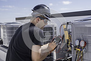 Hvac tech repairing a condensing unit on roof