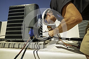 HVAC technician brazing on a condenser