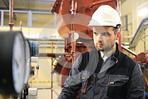 HVAC technician checking pressure gauge on industrial factory. Engineer monitoring manometers