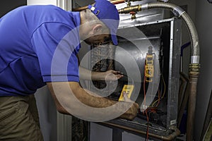 Hvac Technician Checking for Refrigerant Leaks on a Heat Pump