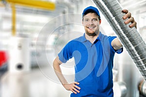 Hvac technician with flexible aluminum ducting tube in hand