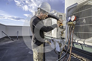 HVAC technician hooking up amp clamp