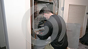 HVAC Technician Removing a Water Source Heat Pump Panel