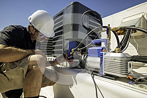 HVAC technician repairing an air conditioner