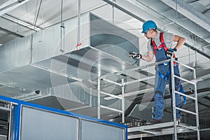HVAC Technician Testing Newly Installed Warehouse Ventilation System