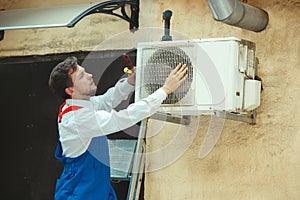 HVAC technician working on a capacitor part for condensing unit