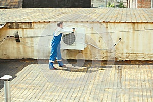 HVAC technician working on a capacitor part for condensing unit