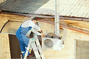 HVAC technician working on a capacitor part for condensing unit