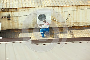 HVAC technician working on a capacitor part for condensing unit