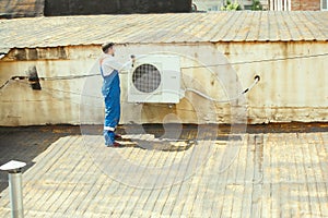 HVAC technician working on a capacitor part for condensing unit