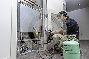 HVAC worker checking refrigerant