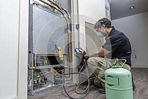 HVAC worker checking refrigerant photo