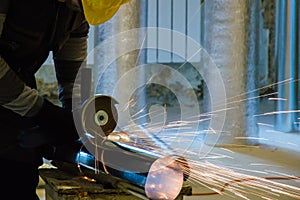 HVAC worker cutting metallic ductwork with the modern angle grinder photo