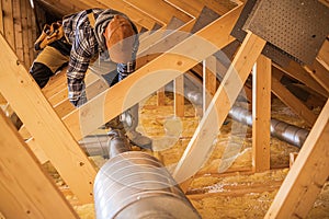 HVAC Worker Installing Air Ducts photo