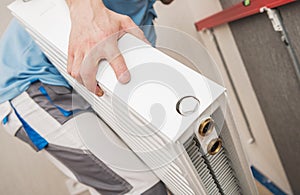 HVAC Worker Installing Residential Heating Radiator