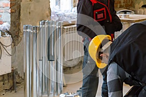 HVAC worker standing near to the metallic ductworks