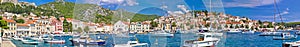 Hvar yachting harbor and historic architecture panoramic photo