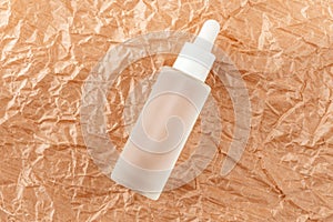 Hyaluronic acid tincture on creased cardboard. Serum with collagen and peptides on wrinkled crumpled paper. Anti-age