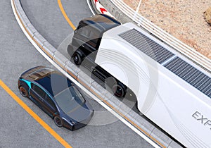 Hybrid electric truck and white electric car on highway