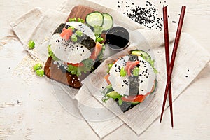 Hybrid modern food. Sushi burger with salmon, white rice, avocado, cucumber