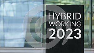 Hybrid Working 2023 sign in front of a modern office building