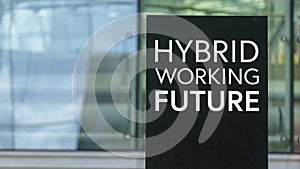 Hybrid Working Future on a sign outside a modern glass office building