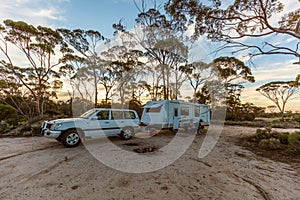 Hyden, Australia - Mar 19,2021: A large white caravan and modern 4WD vehicle in the late afternoon at the free camp at Holt Rock