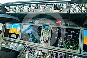 Flight deck of the modern Boeing 737-8 MAX airplane with large primary flight display, navigation display and engine instrument photo