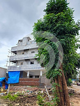 Side view of newly build apartment building in the residential area, construction work is on going.