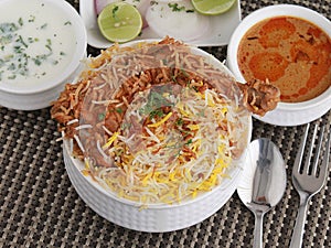 Hyderabad Chicken Dum biryani with korma, curd chutney