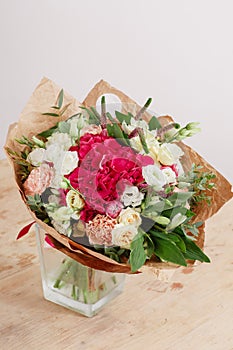 Hydrangea rich bouquet. Vintage floristic background, colorful roses, in crafting the package on the wooden table