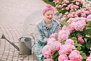 Hydrangea. Spring and summer. happy woman gardener with flowers. Flower care and watering. soils and fertilizers. woman